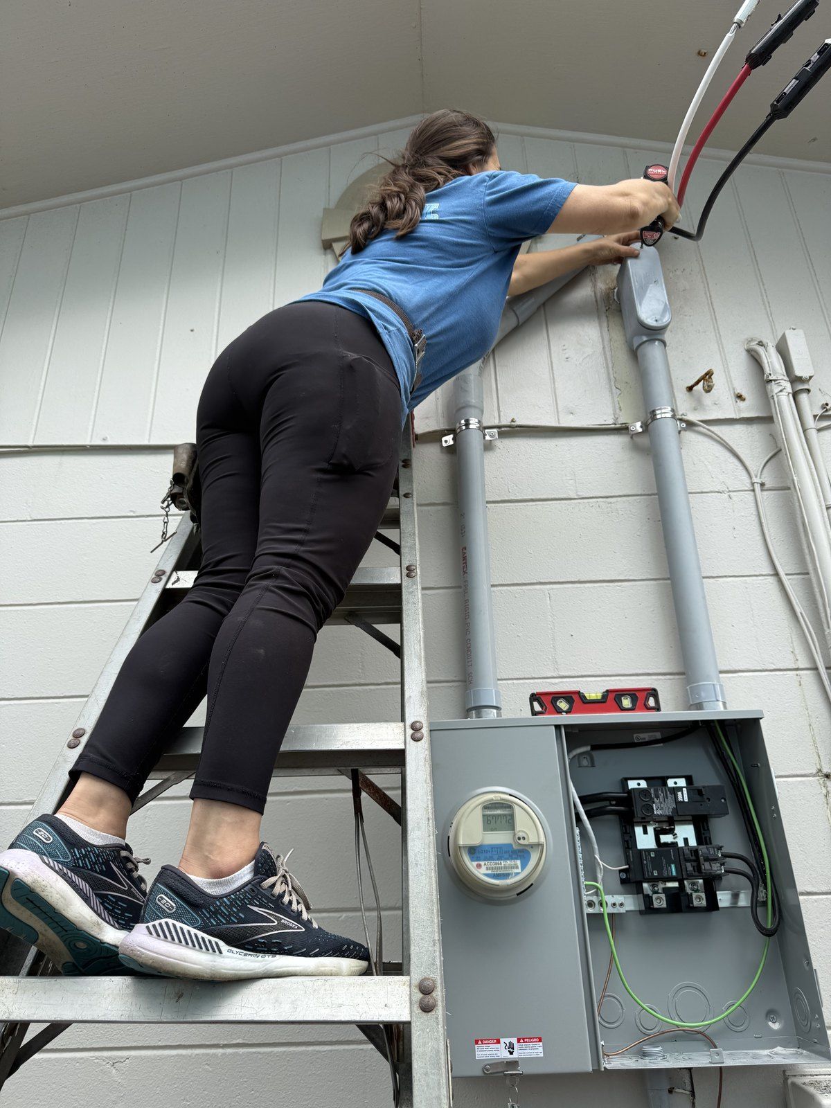 Inside the Blondin Electric van mid-job — stocked wire rack, breakers and hydraulic knockout set